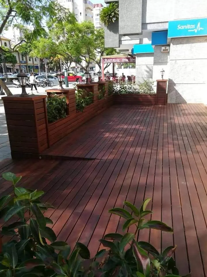 Tarima de madera en ático con jardineras en Marbella